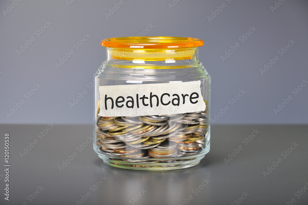 Saving concept of coins in the glass jar for healthcare purpose Saving concept of coins in the glass jar for healthcare purpose
