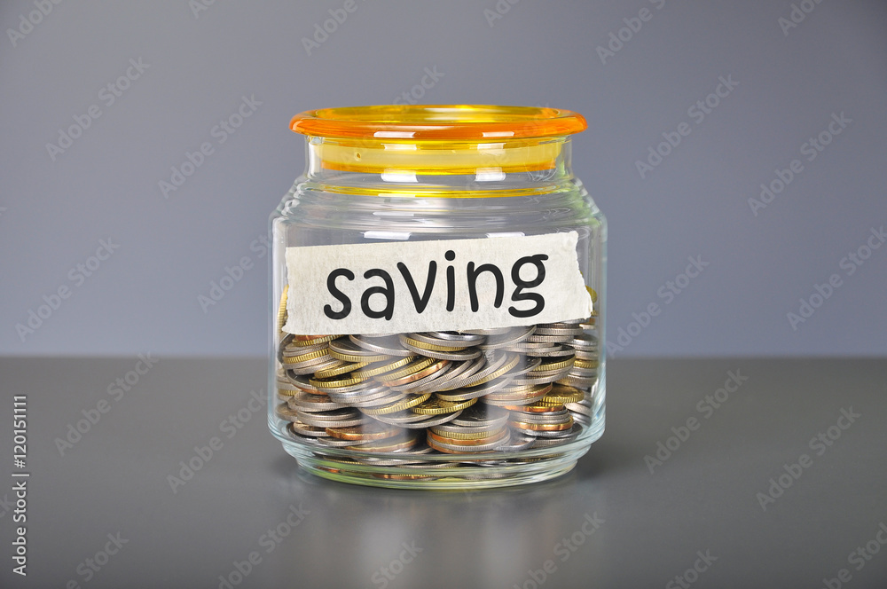 Saving concept of coins in the glass jar for saving purpose Saving concept of coins in the glass jar for saving purpose