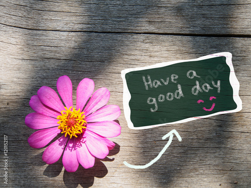 Have a good day wording with fresh flower on wooden background