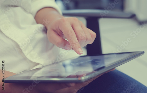 close up business woman hand pointing on smart tablet device for reading email job list:film vintage filter