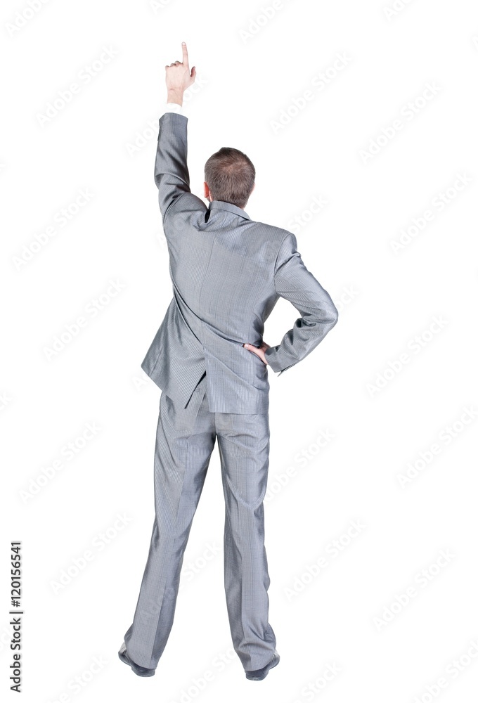 Businessman pointing at wall. rear view. Isolated over white . Businessman pointing at wall. rear view. Isolated over white .