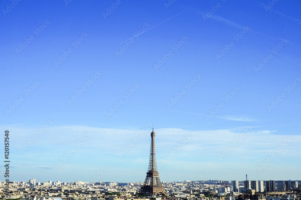 View on Eiffel Tower and Paris Skyline from Arc de Triomphe in the sunny day with blue sky background