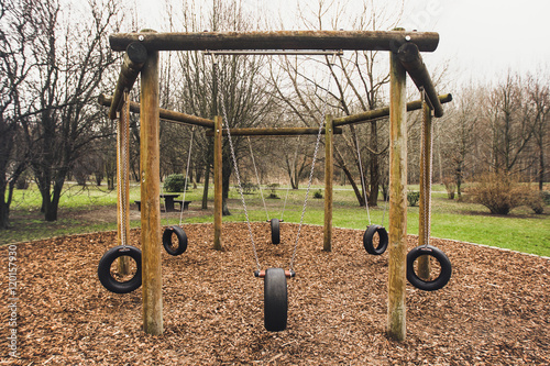 Wooden swing with tires on chain photo