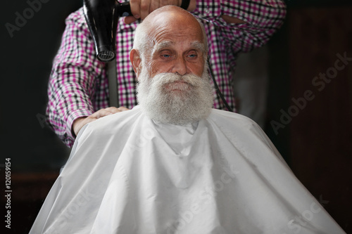 Elderly bearded man at barb...