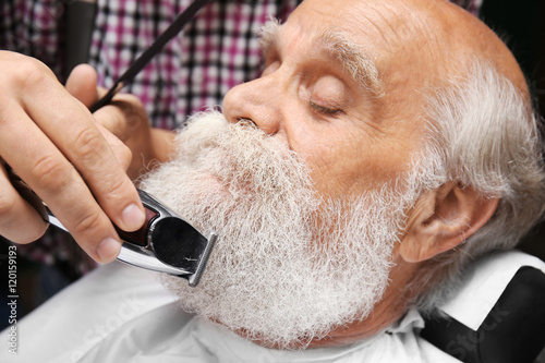 Elderly bearded man at barb...