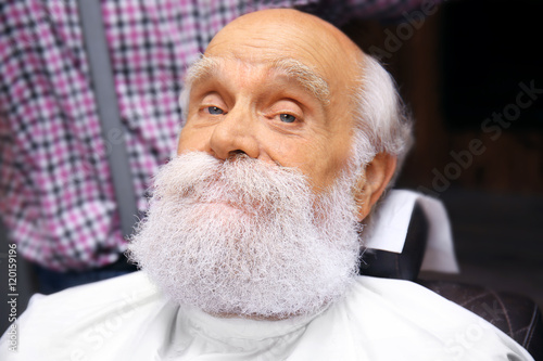 Elderly bearded man at barb...