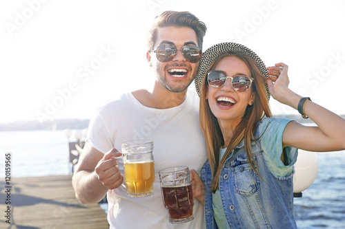 Couple hanging out with beer at the river