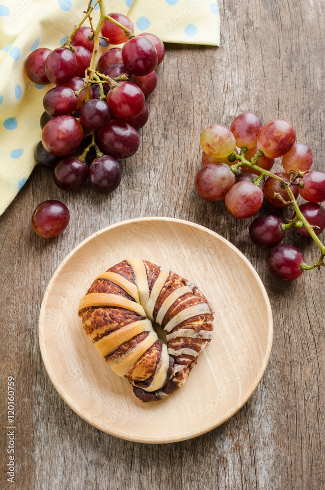 Breakfast with chocolate croissants and fresh grape on old woode Breakfast with chocolate croissants and fresh grape on old woode