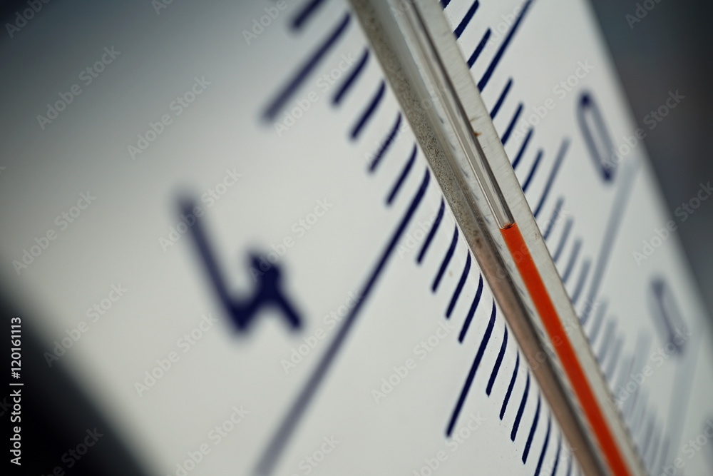 Macro detail of and old dusty outdoor thermometer in the retro design measuring very high temperature of thirty five degrees of Celsius as a symbol of summer and heat Macro detail of and old dusty outdoor thermometer in the retro design measuring very high temperature of thirty five degrees of Celsius as a symbol of summer and heat
