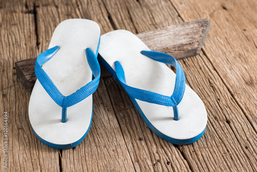 used white and blue rubber slippers on old wood Stock Photo | Adobe Stock