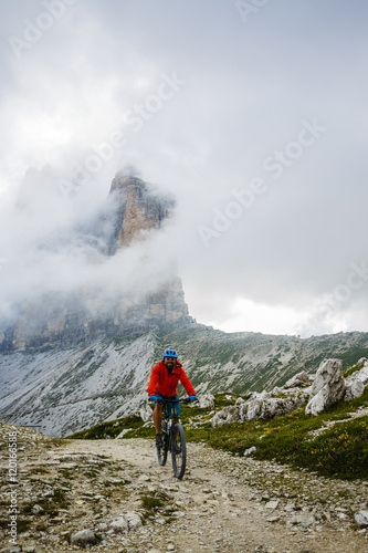 View of cyclist riding mountain bike on trail in Dolomites,Tre Cime di Laverado © Gorilla