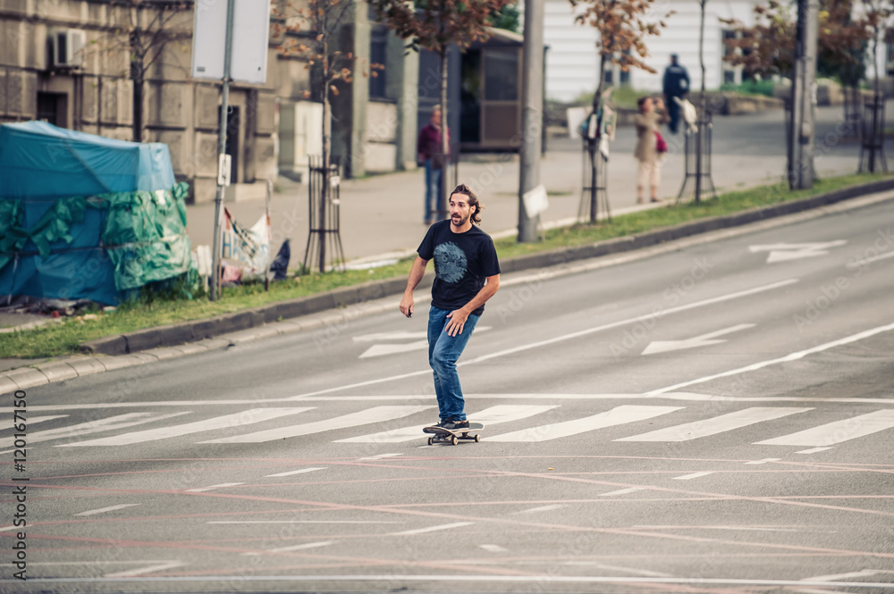 Professional skateboarder riding a skateboard slope on the capital city streets, through cars and urban traffic
