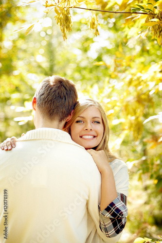 Young woman embracing with her boyfriend, looking at camera and smiling © pressmaster