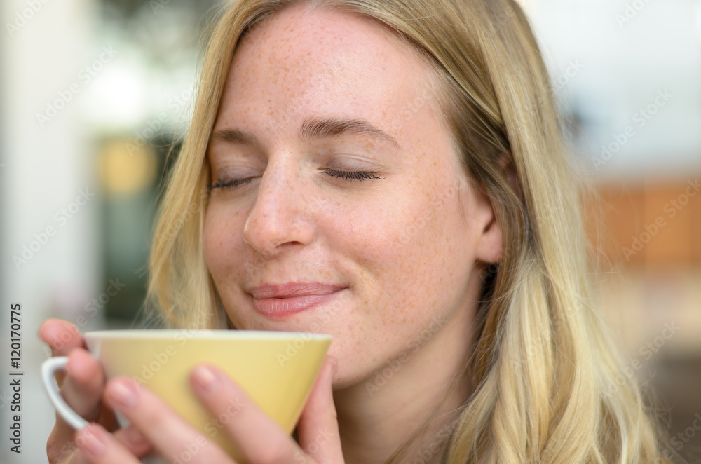 Happy young woman enjoying her morning coffee Happy young woman enjoying her morning coffee