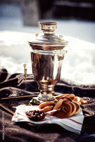 Russian samovar with bagels and jam. Tea party outdoors. Retro