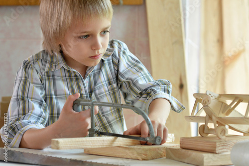 little boy working with wood