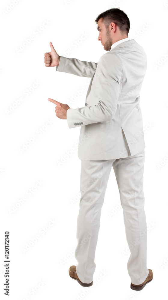 Back view of young business man in white suit going thumb up, isolated on white background. Rear view.Showing of positive emotions with OK sign concept . Back view of young business man in white suit going thumb up, isolated on white background. Rear view.Showing of positive emotions with OK sign concept .