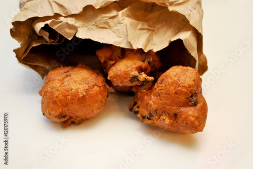 Traditional American Clam Fritters Falling From a Take-Out Bag photo