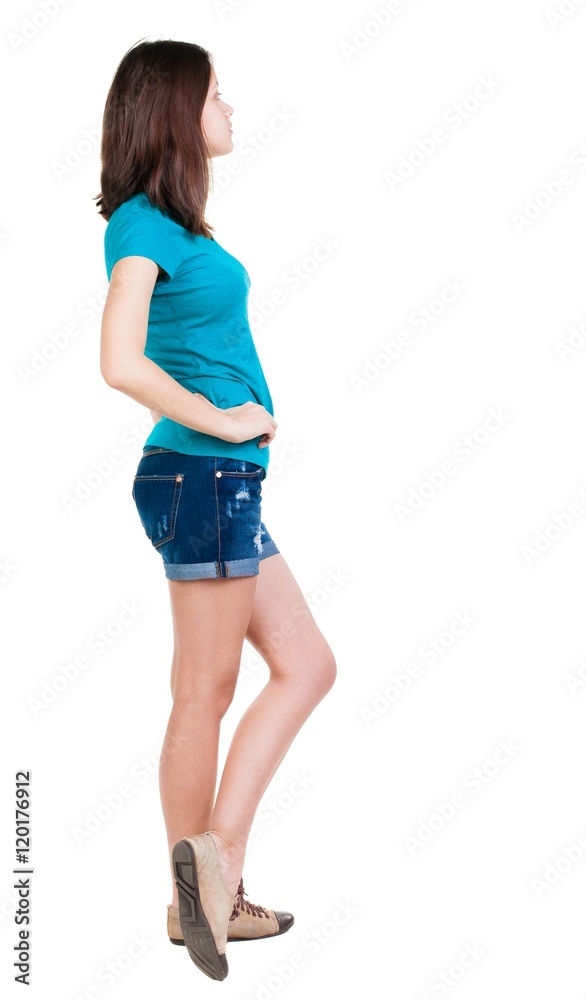 back view of standing young beautiful brunette woman in shorts. girl watching. Rear view people collection. backside view of person. Isolated over white background. back view of standing young beautiful brunette woman in shorts. girl watching. Rear view people collection. backside view of person. Isolated over white background.