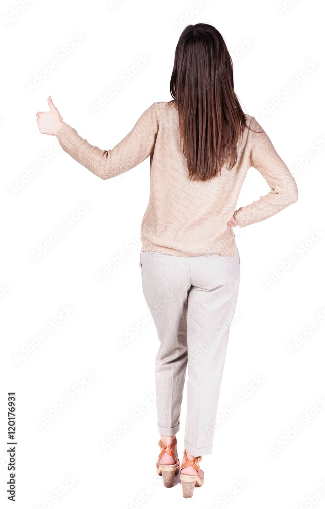 Back view of woman thumbs up. Rear view people collection. backside view of person. Isolated over white background. slender brunette in a jeans shows the symbol of success or hitchhiking Back view of woman thumbs up. Rear view people collection. backside view of person. Isolated over white background. slender brunette in a jeans shows the symbol of success or hitchhiking