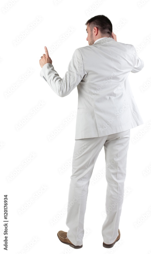 Back view of thinking young business man in white suit. Rear view. isolated over white background. Concept of idea, ask question, think up, choose, decide. Back view of thinking young business man in white suit. Rear view. isolated over white background. Concept of idea, ask question, think up, choose, decide.