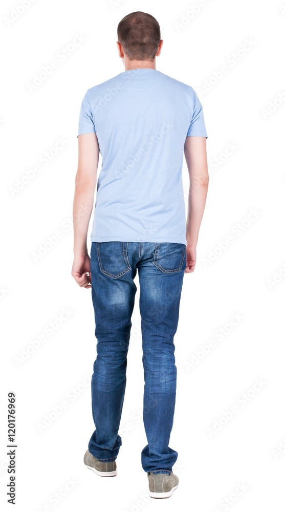 Back view of young man in t-shirt and jeans looking. guy standing putting one foot in front. Rear view people collection. backside view of person. Isolated over white background. Back view of young man in t-shirt and jeans looking. guy standing putting one foot in front. Rear view people collection. backside view of person. Isolated over white background.