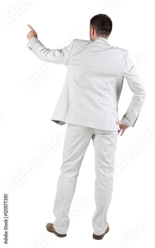 Businessman pointing at wall. rear view. Isolated over white . 