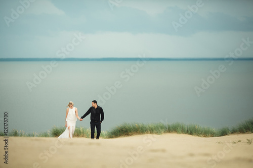 happy man and his wife walking near the sea © andriychuk
