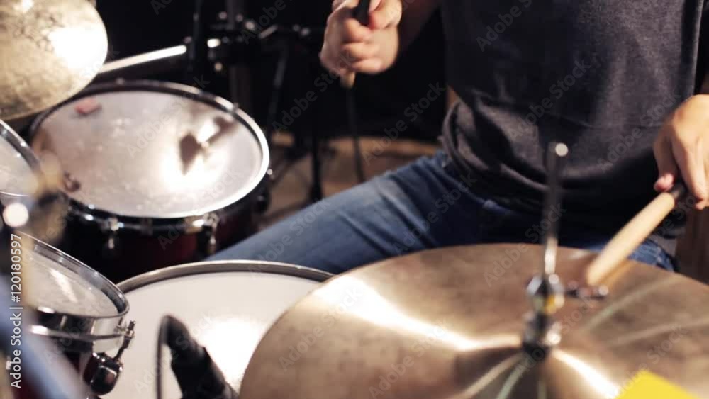 male musician playing drums and cymbals at concert male musician playing drums and cymbals at concert