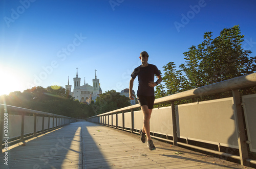 Man running near Fourviere Basilica in Lyon on a summer morning.