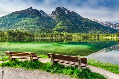 Two wooden bench at the Hintersee lake in the Alps
