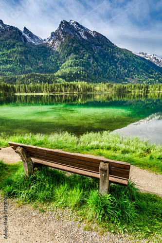 Small bench at the Hintersee lake at sunrise