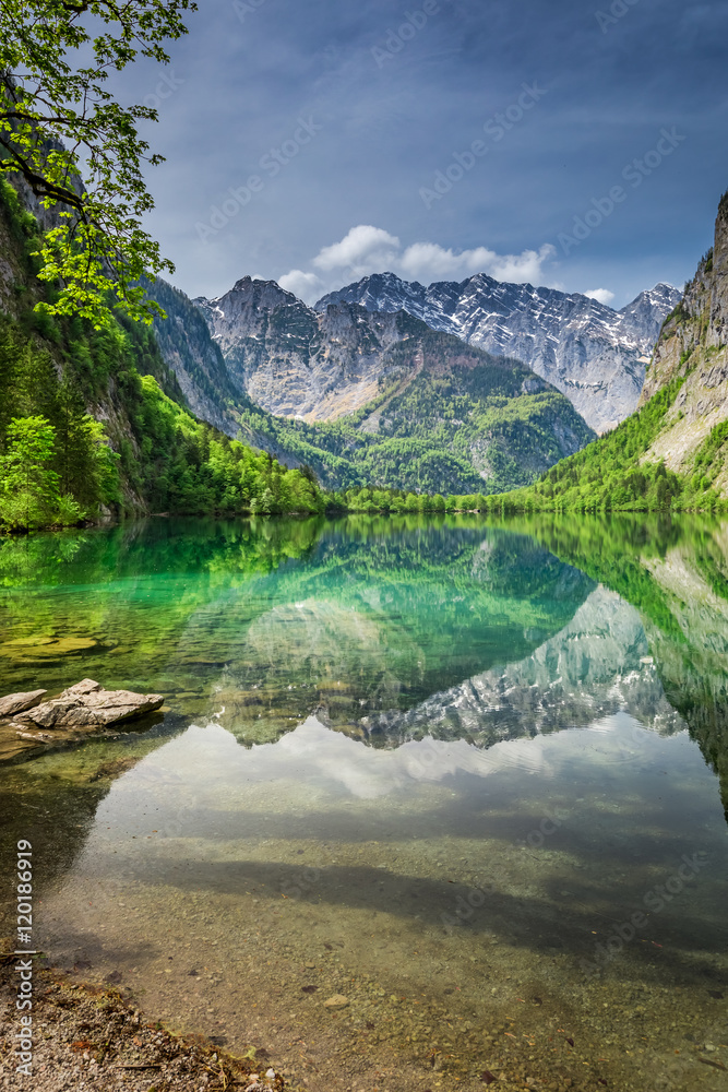 Mirror reflection of the Alps in green Obersee lake, Germany