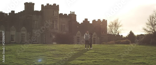 Amazing cuple walk near castle photo