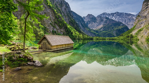 Beautiful view of a small cottage on the lake Obersee in Alps, Germany