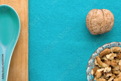 Walnuts. Top view of wooden Board and blue background. For kitchen and menu 