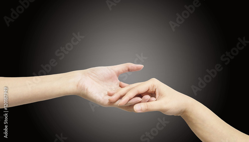 Closeup woman hand hold another woman hand for console and encourage in tender emotion isolated on black background