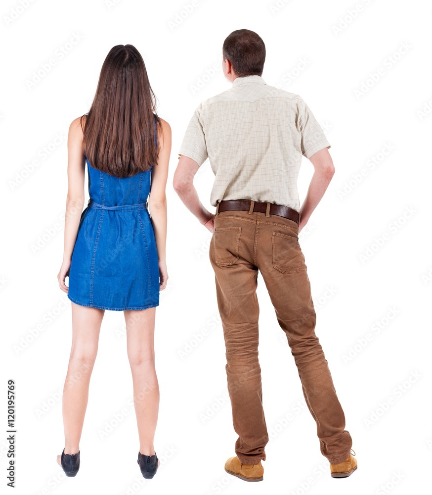 Back view of young couple man and woman hug and look into the distance. beautiful friendly girl and guy together. Rear view. Isolated over white background. young woman holds the hand of her husband Back view of young couple man and woman hug and look into the distance. beautiful friendly girl and guy together. Rear view. Isolated over white background. young woman holds the hand of her husband