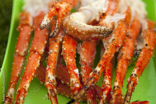 Boiled leg of the royal king crab on a green tray