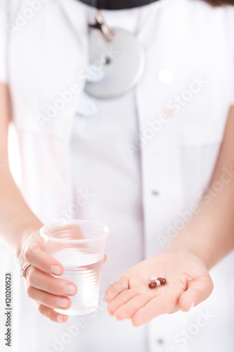  pill and a glass of water, close-up