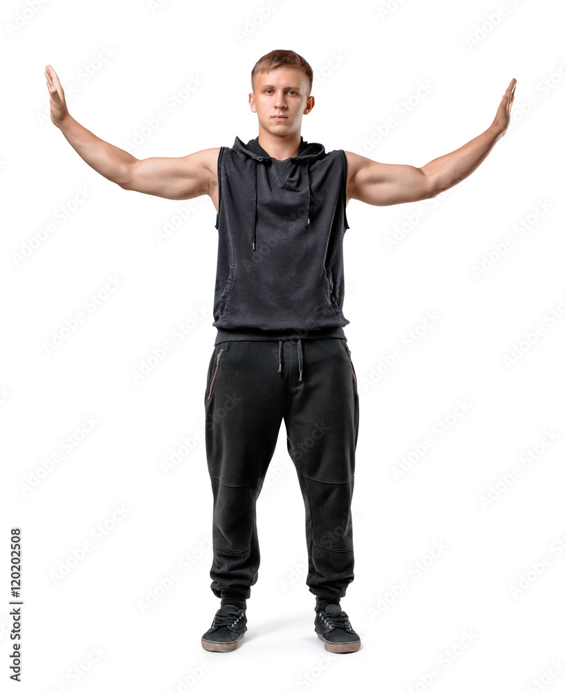 Muscled young man stands pushing invisible walls with his hands isolated on white background Muscled young man stands pushing invisible walls with his hands isolated on white background