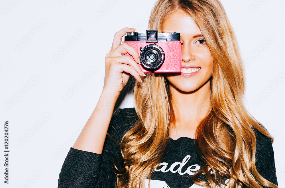 Beautiful Hipster woman taking photos with pink retro film camera on white  background. Close up. Indoor. Warm color. Stock Photo | Adobe Stock