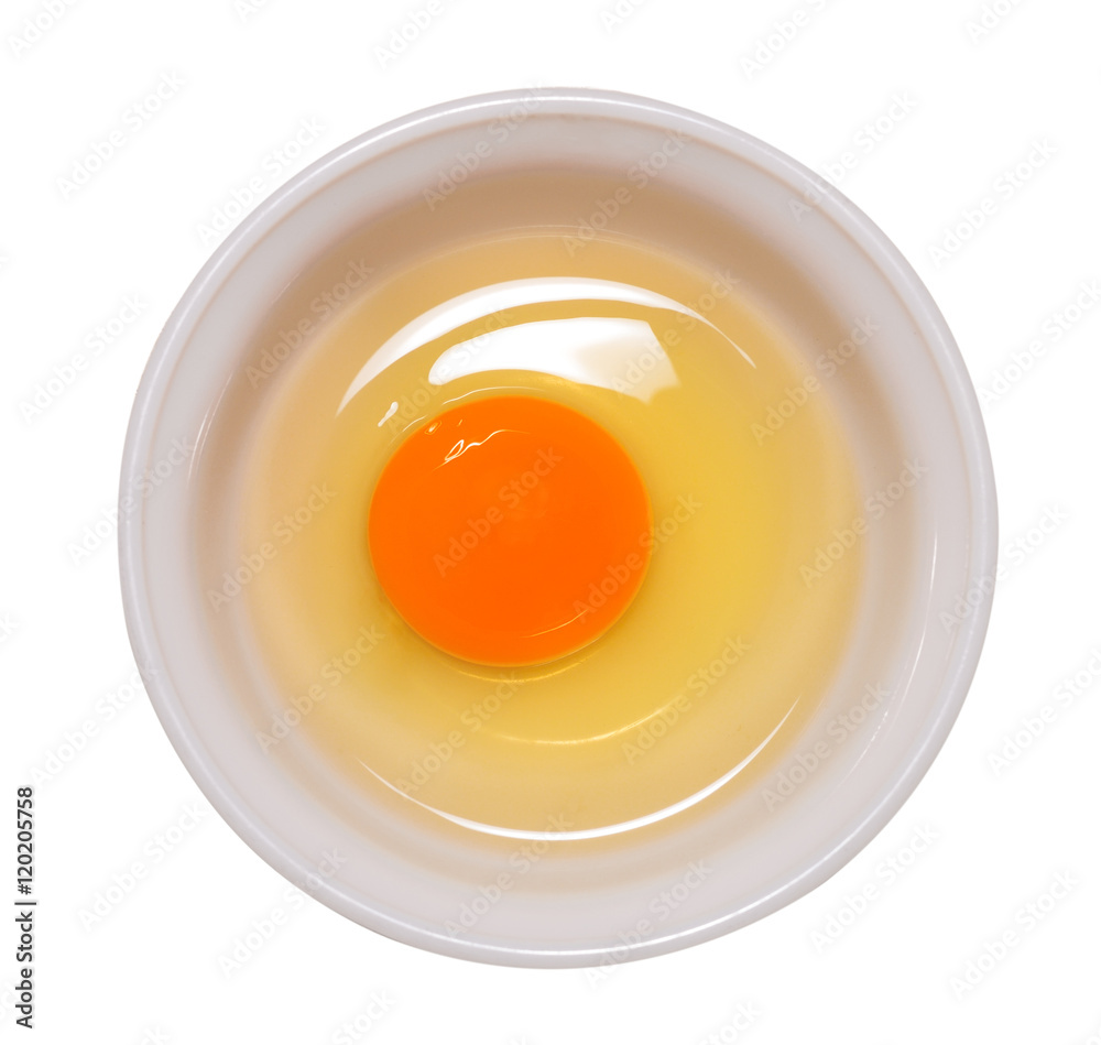 Egg yolk and white in a white bowl isolated on white
