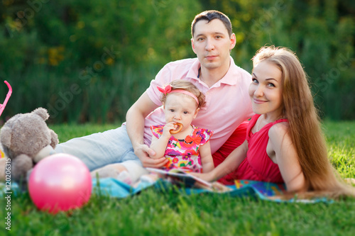 Happy young family spending time outdoor on summer day
