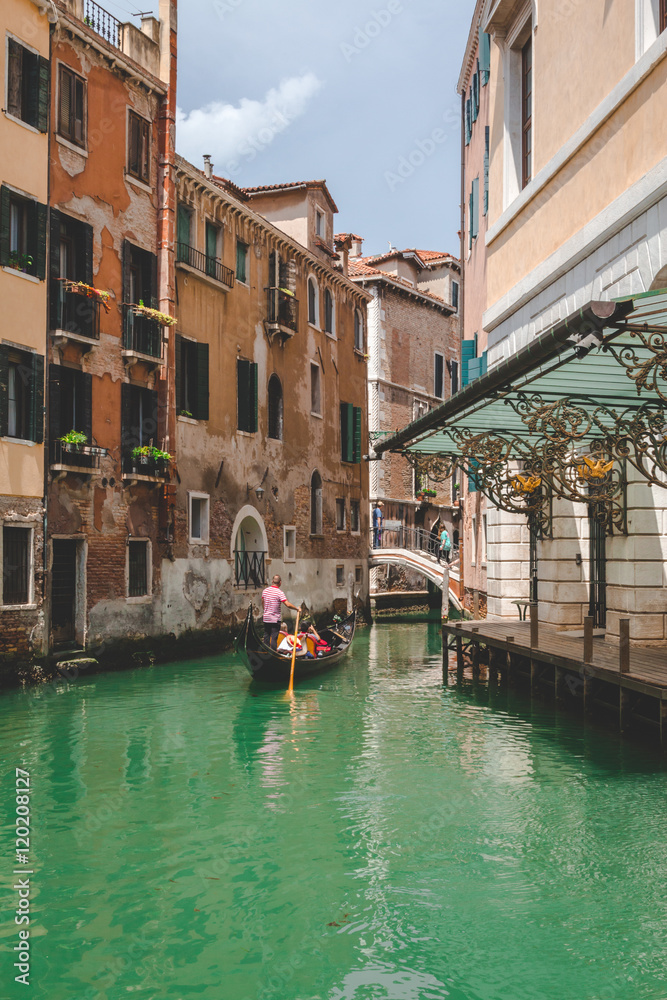 Canal, gondola and houses in Venice