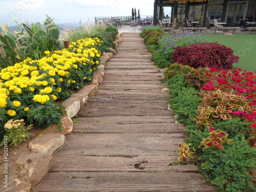 Colorful Flower Bed along the Wooden Walkway of the Front yard 