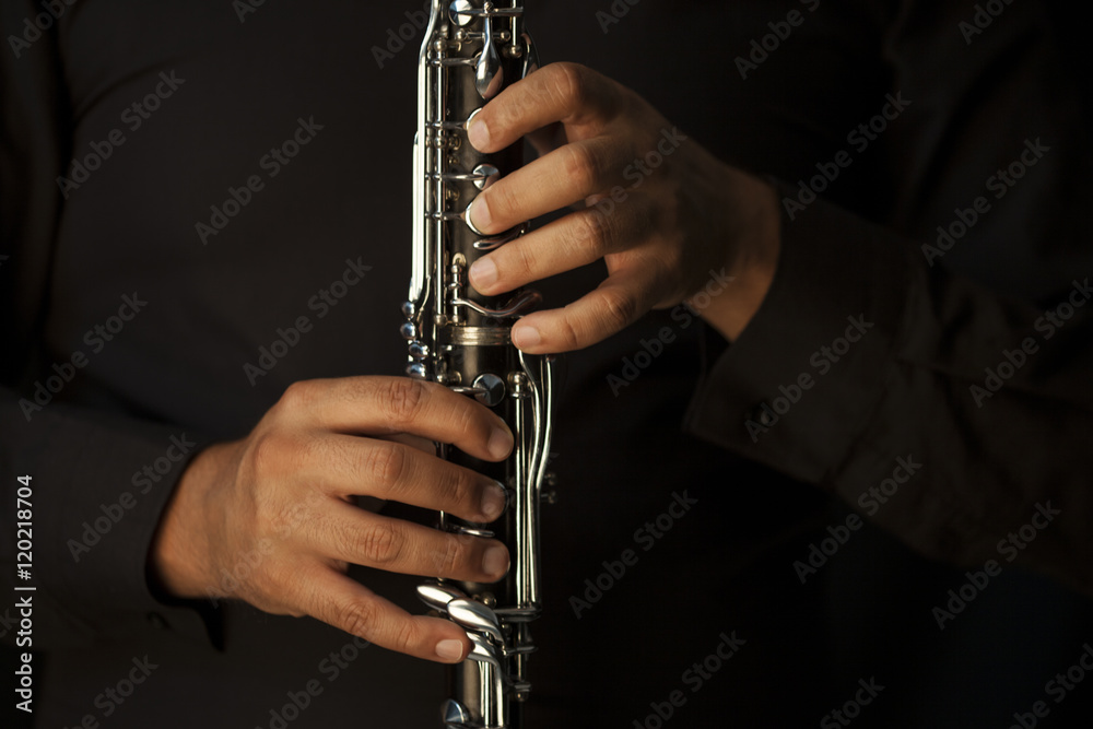 Fototapeta premium Hands of a clarinet player in black