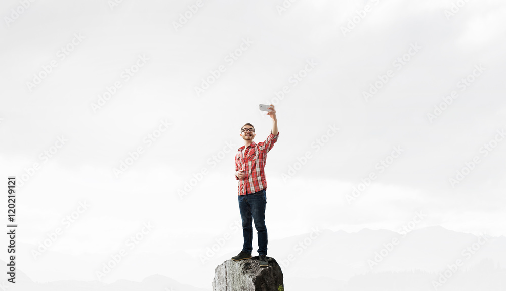 Hipster guy use his smartphone . Mixed media Hipster guy use his smartphone . Mixed media