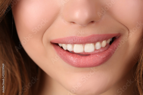 Smiling lady biting her lip. Close up