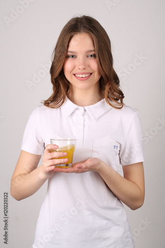 Model posing with glass of juice. Close up. White background